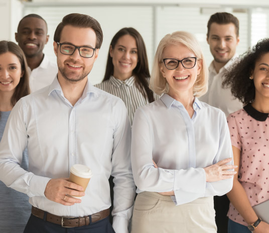  A diverse group of business professionals standing together in a meeting room, discussing ideas and collaborating on projects.